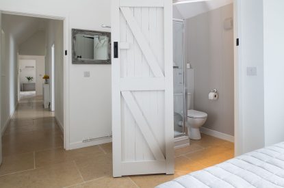A double bedroom with an ensuite at Farmyard Cottage, Wiltshire