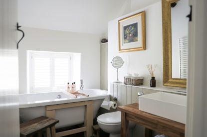 The bathroom with a free standing bath at Rambling Rose Cottage, Cotswolds