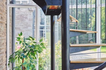 The spiral staircase with views over the lake at Osborne Lodge, Herefordshire