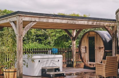 The hot tub and barrel sauna in the garden at Osborne Lodge, Herefordshire