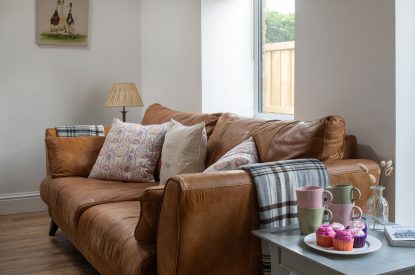 The sofa in the living room at The Milking Parlour, Wiltshire 