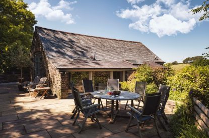 The private patio with an outdoor dining table at Fern House, Devon