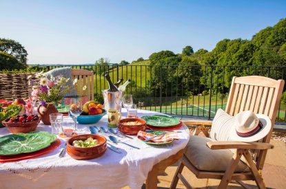 The outdoor dining table overlooking the estate grounds at Georgian House, Devon