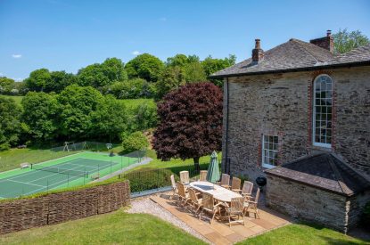 The exterior of Georgian House, Devon overlooking the tennis court