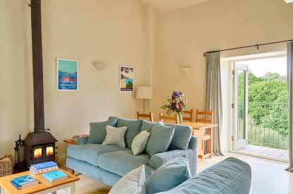 The living room with a log burner at Tigley Cottage, Devon