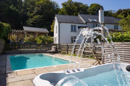 The hot tub and swimming pool at Little Haven, Gower