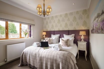 A super king size bedroom at The Clans, Fife