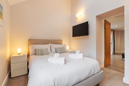 A super king size bedroom at Oxwich Retreat, Gower