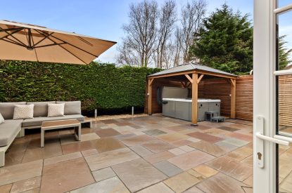 The terrace with hot tub at Oxwich Retreat, Gower