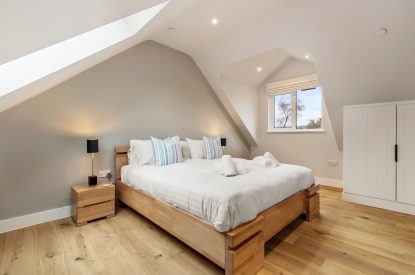 A super king size bedroom at Oxwich Retreat, Gower