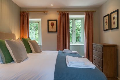 A super king sized bedroom at Poppy Cottage, Somerset