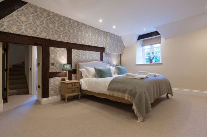 A super king sized bedroom at The Thatched Cottage, Somerset