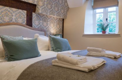A super king sized bedroom at The Thatched Cottage, Somerset