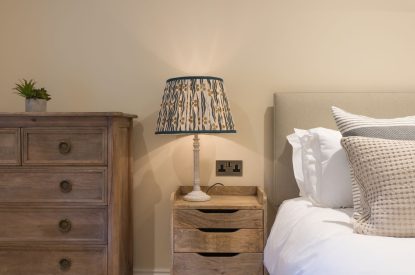 A super king sized bedroom at The Thatched Cottage, Somerset