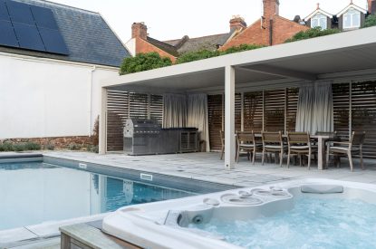 The hot tub and swimming pool area at White Exeter House, Devon