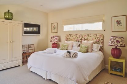 A super king sized bedroom at Hockham Pool House, Norfolk Coast