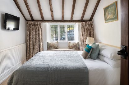 A king sized bedroom at The Old Post Office, Cotswolds