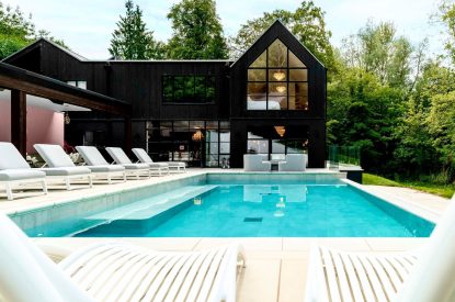 The heated outdoor swimming pool at Halo House, Cotswolds