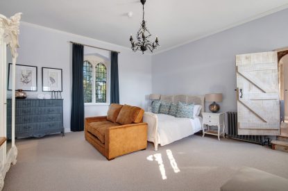 A king-size bedroom at The Priory Gatehouses, Essex