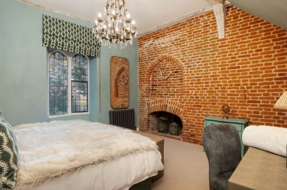 A king-size bedroom at The Priory Gatehouses, Essex