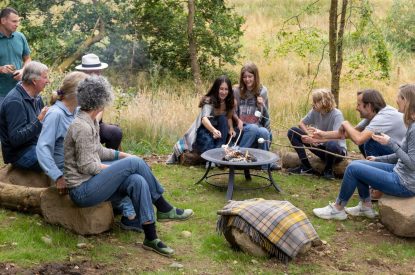 A family sat around the fire pit at Ermine, Scotland