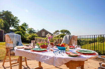The outdoor dining table overlooking the countryside at Georgian House, Devon