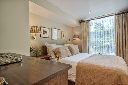A king-size bedroom at Olive Orchard, Cotswolds