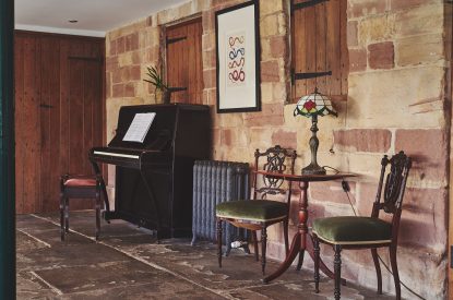 The piano in the sunroom at Heron House, Peak District