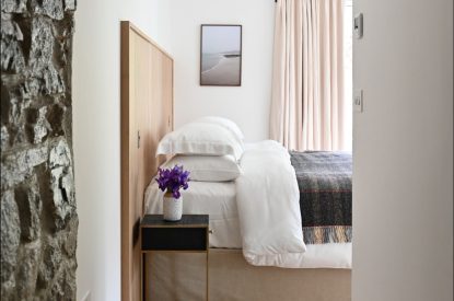 A super king size bedroom at Map Maker's Cottage, Roundstone, Galway
