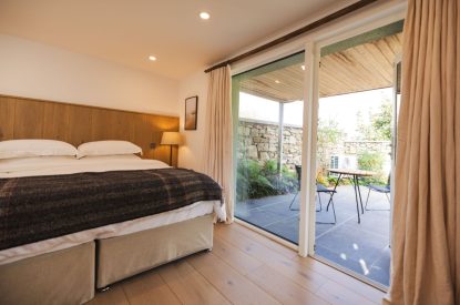 A super king size bedroom at Map Maker's Cottage, Roundstone, Galway