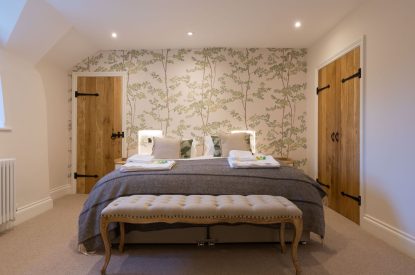 A super king sized bedroom at The Thatched Cottage, Somerset