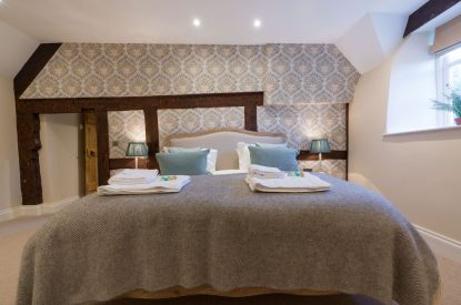A super king sized bedroom at The Thatched Cottage, Somerset
