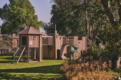 The playground with a climbing wall and slide at The Byre, Welsh Borders
