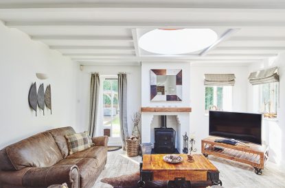 The living room with a log burner at Osborne Lodge, Herefordshire