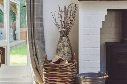 The log basket next to the log burner at Osborne Lodge, Herefordshire