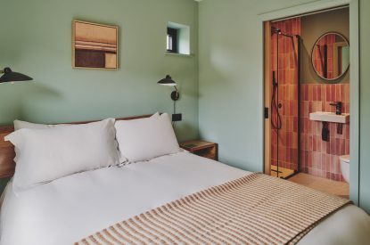 A king-size bedroom and en-suite bathroom at Haymill Retreat, Powys