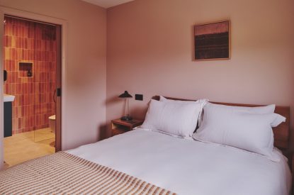 A king-size bedroom and en-suite bathroom at Haymill Retreat, Powys