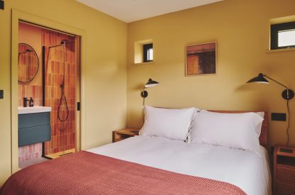 A king-size bedroom and en-suite bathroom at Haymill Retreat, Powys