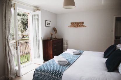 A super-king-size bedroom at The Coachman's House, Wiltshire