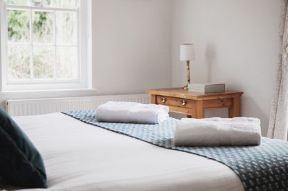 A super-king-size bedroom at The Coachman's House, Wiltshire