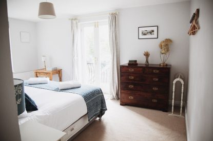 A super-king-size bedroom at The Coachman's House, Wiltshire