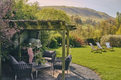 The outdoor seating area with pizza oven at Hall House, Powys