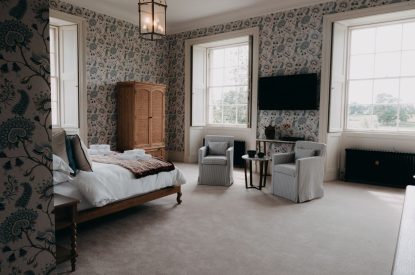 A king-size bedroom at Stoke Hall, Nottinghamshire