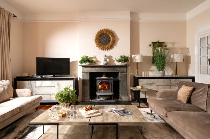 The living room and log burner at The Victorian Manor, Dorset