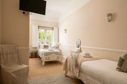 A twin bedroom at The Victorian Manor, Dorset