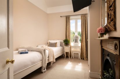 A twin bedroom at The Victorian Manor, Dorset