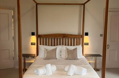 A king-size four poster bed at Bracken Grange, Ceredigion