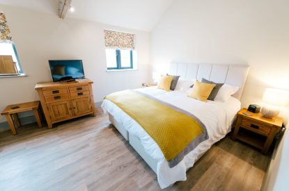 A super-king-size bedroom at Malbank Barn, Cheshire