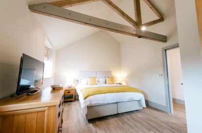 A super-king-size bedroom at Malbank Barn, Cheshire