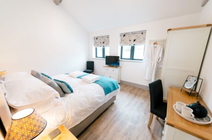 A super-king-size bedroom at Malbank Barn, Cheshire